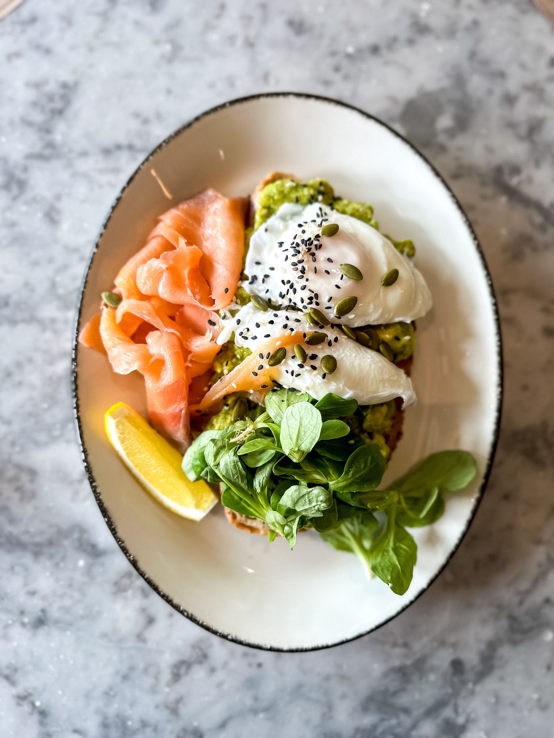 Healthy food. Toast with avocado, smoked salmon and poached eggs.